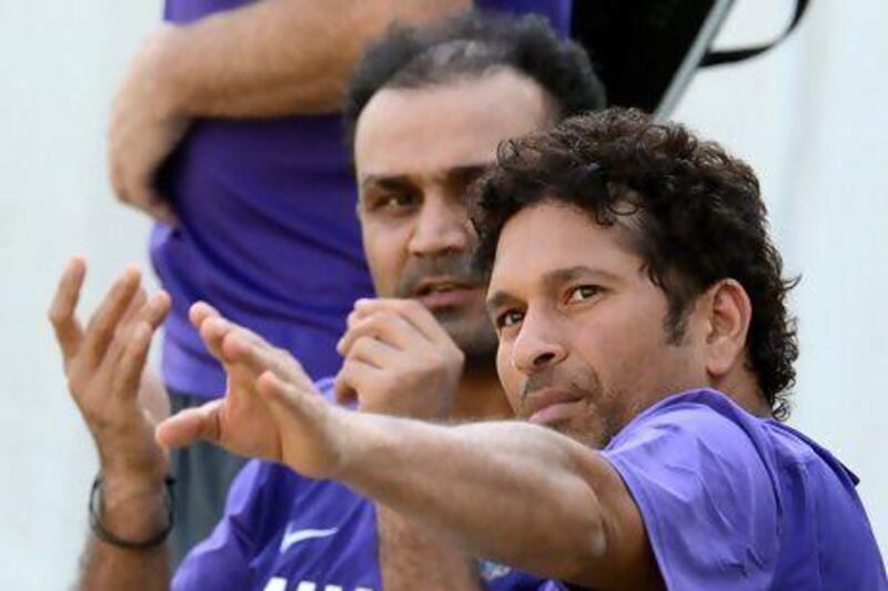 Sachin Tendulkar, right, retired from the India ODI team after 23 years. Punit Paranjpe / AFP