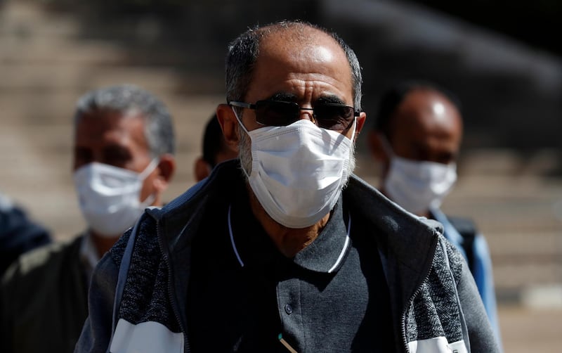 People wear protective face masks as a precaution against the spread of the coronavirus Covid-19. EPA