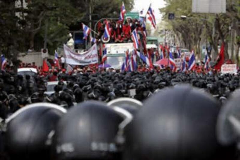 Thai protesters ride on a truck as they try to break through lines of riot police officers during a protest outside parliament in Bangkok, Thailand, on Dec 30 2008.