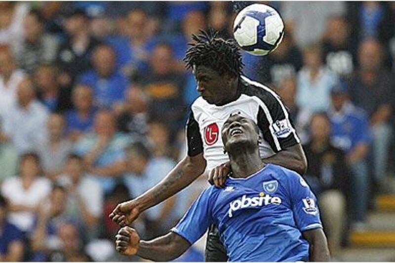 Portsmouth's Papa Bouba Diop, bottom challenges Fulham's Dickson Etuhu during Pompey's opening day defeat at Fratton Park.