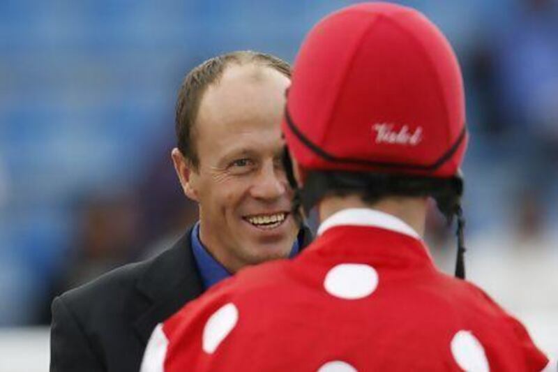 Ernst Oertel, the South African trainer, seen here speaking with the jockey Ted Duncan, has saddled 16 winners and seen Dh1.8million in winnings since taking over Al Asayl Stables 12 months ago. Mike Young / The National