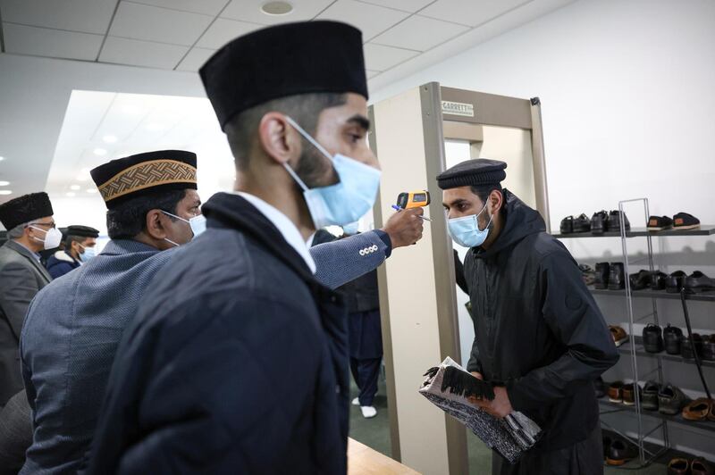 Worshippers have their temperature checked before attending prayers at the Baitul Futuh mosque in south London. Reuters