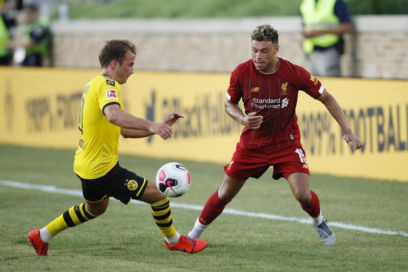 Alex Oxlade-Chamberlain looks to win the ball for Liverpool on the flank.