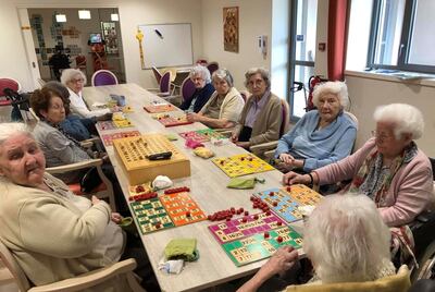 In this photo provided by the Vilanova nursing home, residents play inside the Vilanova nursing home on April 30 2020 in Corbas, central France. As the coronavirus cut a deadly path through nursing homes, staff locked themselves in with the 106 residents at this care home to stop COVID-19 coronavirus from infecting and killing the vulnerable older adults in their care, and they have not had any people falling victim to the virus.(Valerie Martin via AP)