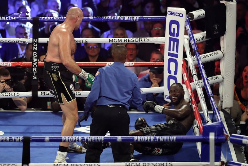 Tyson Fury watches Deontay Wilder hit the canvas.