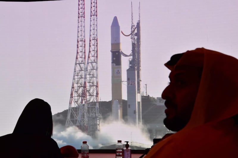 A picture taken on July 19, 2020, shows a screen broadcasting the launch of the "Hope" Mars probe at the Mohammed Bin Rashid Space Centre in Dubai. The probe is one of three racing to the Red Planet, with Chinese and US rockets also taking advantage of the Earth and Mars being unusually close: a mere hop of 55 million kilometres (34 million miles). "Hope" -- Al-Amal in Arabic -- is expected to start orbiting Mars by February 2021, marking the 50th anniversary of the unification of the UAE. / AFP / Giuseppe CACACE
