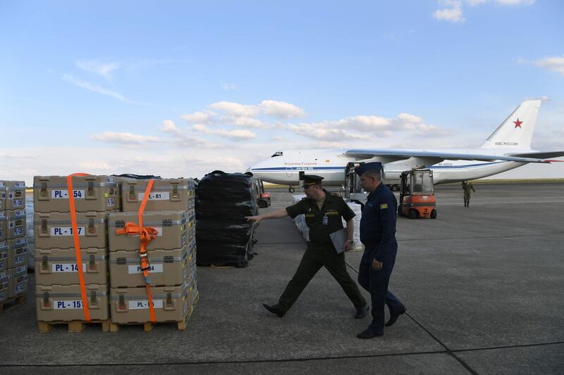 Russian military service personnel check crates containing humanitarian aid before being loaded onto an Antonov An-124 Ruslan - Widebody at the former Chateauroux-Deols Marcel Dassault Airport in central France on July 20, 2018.  France and Russia are jointly delivering humanitarian aid to the former Syrian rebel enclave of Eastern Ghouta, the French Presidency said in a statement with Russia on July 20. A Russian cargo plane arrived late in Chateauroux to load 50 tons of medical equipment and essential goods provided by France, said an AFP videographer at the scene, to be transported to the former rebel area which was recaptured by Syrian troops this Spring.
 / AFP / Alain JOCARD
