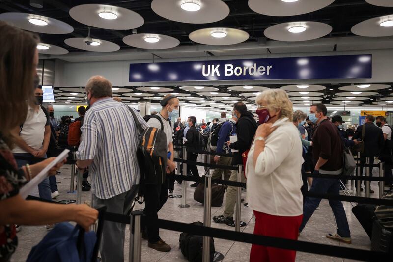 Arriving passengers queue at UK Border Control at the Terminal 5 at Heathrow Airport.