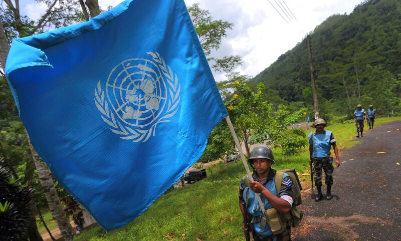 FILE - In this Sept. 13, 2016 photo, a Sri Lanka Air Force airman carries the U.N. flag during training for a road patrol at the Institute of Peace Support Operations Training in Kukuleganga, Sri Lanka. A U.N. fund to help victims of sexual abuse and exploitation by peacekeepers and U.N. staff has now grown to $1.5 million following contributions from 10 more countries including Sri Lanka, whose troops were implicated in a three-year-long child sex ring in Haiti. The U.N. Department of Field Support made the announcement Thursday, Sept. 28, 2017 in New York. (AP Photo/Eranga Jayawardena, file)