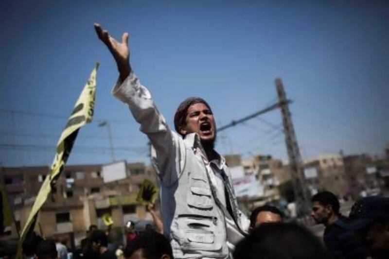 A supporter of Mohammed Morsi chants slogans against the Egyptian army during a march following Friday prayers at Nasr City in Cairo.