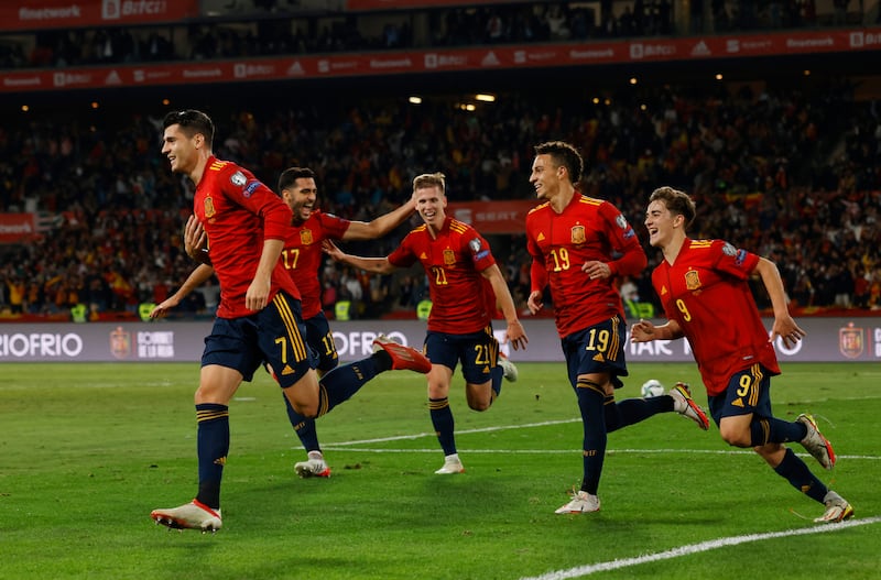 Spain's Alvaro Morata celebrates scoring their first goal with teammates. Reuters