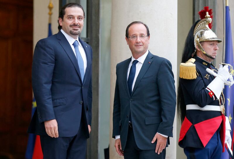 France's former president Francois Hollande, right, welcomes Mr Hariri to a meeting at the Elysee presidential palace, in 2012.