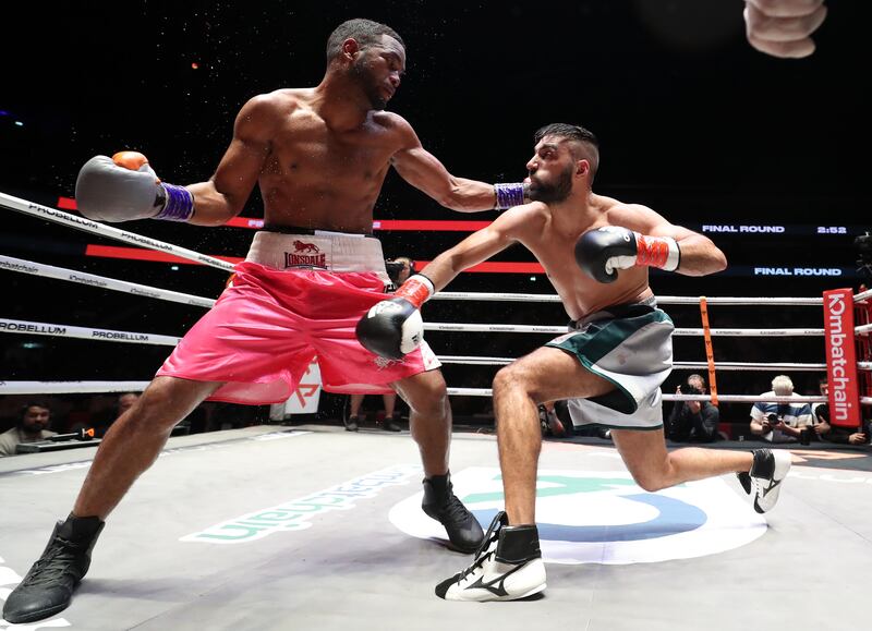 Kelvin Dotel (pink) takes on Rohan Date (grey) in a Super Featherweight bout at the Coca Cola Arena, Dubai. Chris Whiteoak/ The National