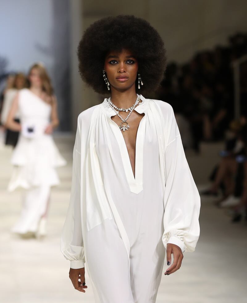 A fluid all-white kaftan on the runway as part of the Chanel cruise 2021-22 show in Dubai