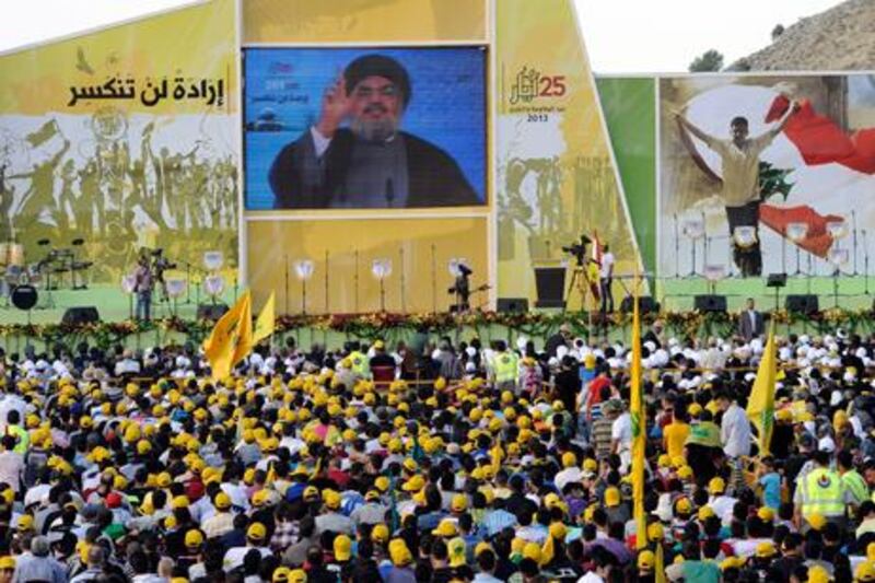 Supporters of Hezbollah listen to the Secretary General of Hezbollah Sayyed Hassan Nasrallah, speaking on a giant screen via video link from an undisclosed location.  EPA / Wael Hamzeh