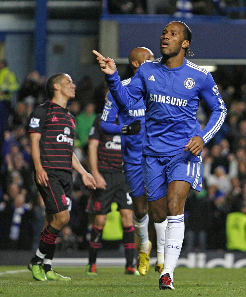 Chelsea's Ivorian striker Didier Drogba (R) celebrates scoring his second goal during the English Premier League football match between Chelsea and Everton at Stamford Bridge, London on December 12, 2009. AFP PHOTO / Ian Kington

FOR EDITORIAL USE ONLY Additional licence required for any commercial/promotional use or use on TV or internet (except identical online version of newspaper) of Premier League/Football League photos. Tel DataCo +44 207 2981656. Do not alter/modify photo. (Photo by IAN KINGTON / AFP)