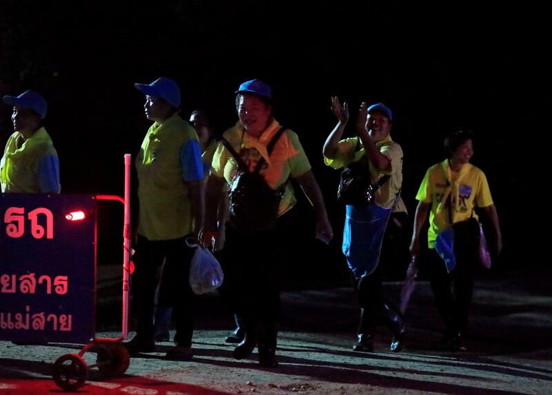 Volunteers celebrate near Tham Luang cave complex. Reuters