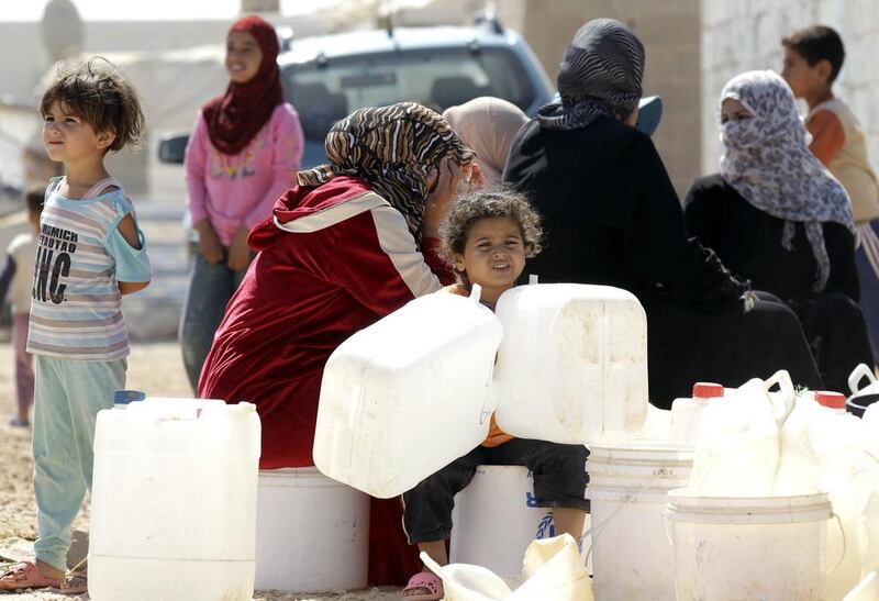 Syrian refugees at the Zaatari refugee camp near the Jordanian city of Mafraq. The camp is home to 115,000 Syrians. Khalil Mazraawi / AFP