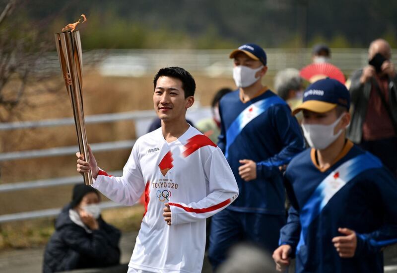 Ryo Matsumoto, a student of Nippon Sport Science University, carries the Olympic torch. AFP