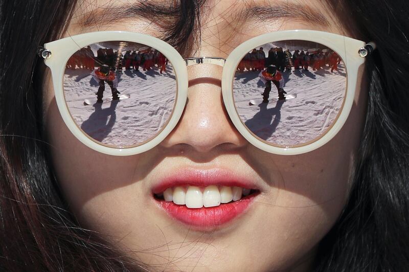 Yuka Fojimori of Japan is reflected in the sunglasses of a volunteer during the Women's Snowboard slopestyle training session in the Phoenix Snow Park, which will host the Freestyle Skiing and Snowboard events of the PyeongChang 2018 Olympic Games. Fazry Ismail / EPA
