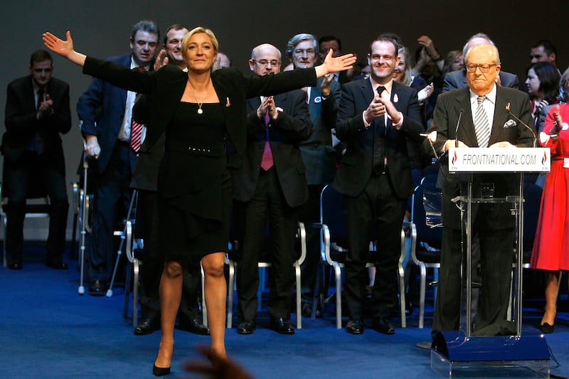 Marine Le Pen salutes party members, with her father to the right, as she is named Front National's new leader at a party conference in January 2011.