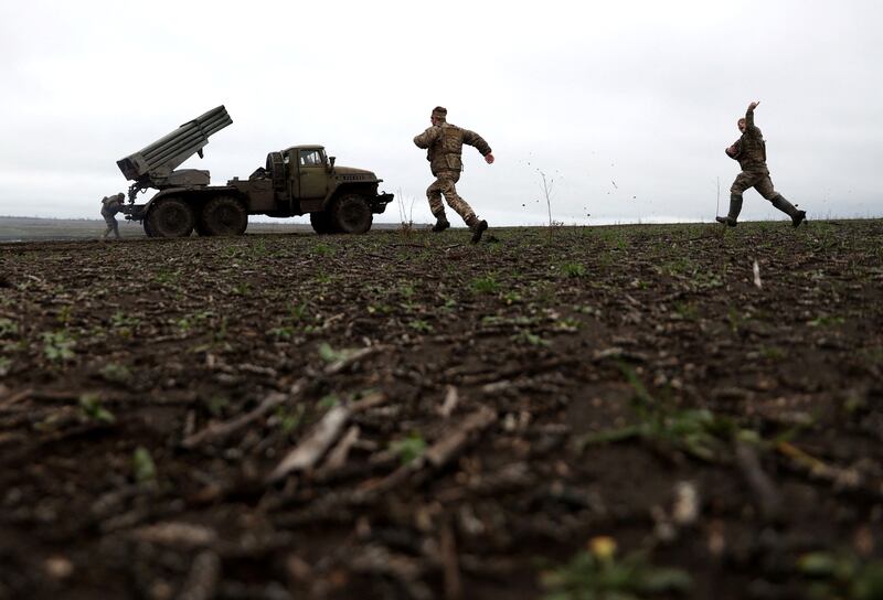 Ukrainian servicemen rush to change their BM-21 Grad's position after firing towards Russian positions on the front line near Bakhmut, eastern Ukraine. AFP

