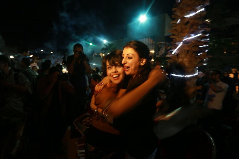 People celebrate Palestinian singer Mohammed Assaf winning "Arab Idol" in Gaza city  on June 22, 2013. The 22-year-old Assaf, from the Gaza Strip, was named the winner of "Arab Idol" in a TV talent contest in Beirut.   AFP PHOTO/MOHAMMED ABED
 *** Local Caption ***  403629-01-08.jpg