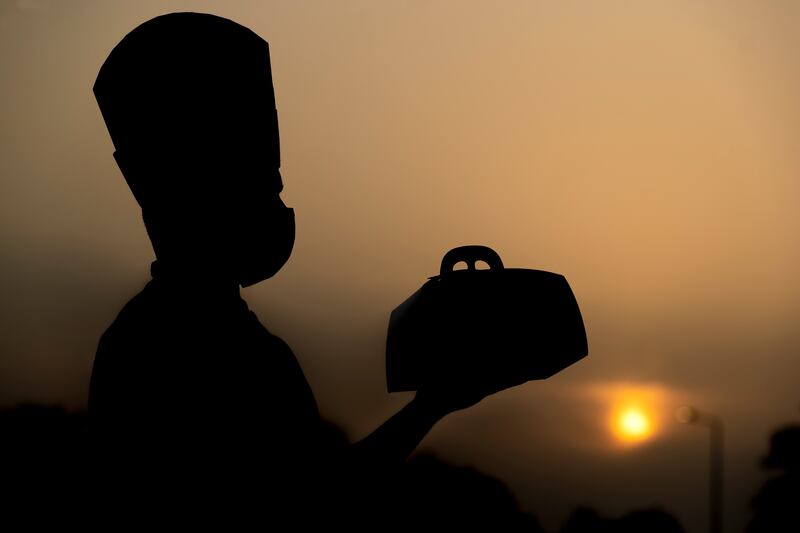 The hotel is handing out free iftar boxes and water to taxi drivers and delivery riders. Chris Whiteoak / The National