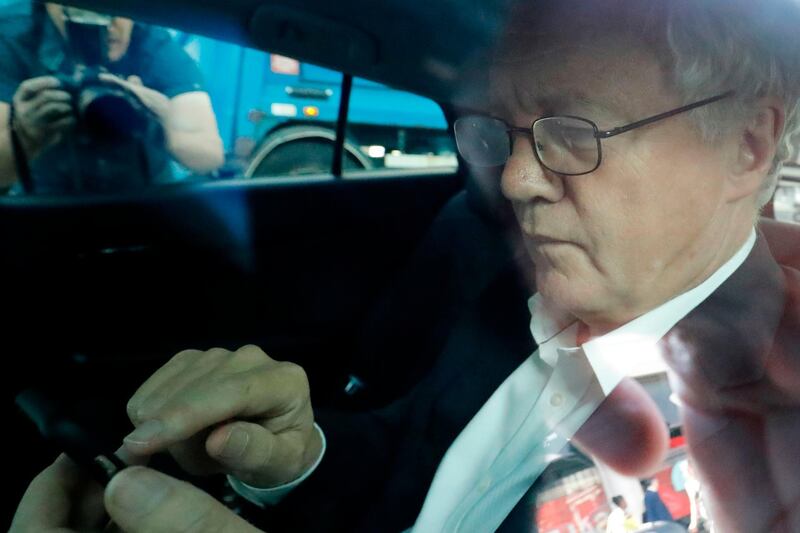 British conservative MP David Davis writes a message on his phone in the back of a car as he leaves Broadcasting House after a radio interview in London on July 9, 2018 after Davis resigned as Secretary of State for Exiting the European Union (Brexit Minister). British Prime Minister Theresa May faced a crisis in her cabinet on July 9 after Brexit minister David Davis and two of his deputies resigned over a plan to retain strong economic ties to the EU even after leaving the bloc. / AFP / Tolga AKMEN
