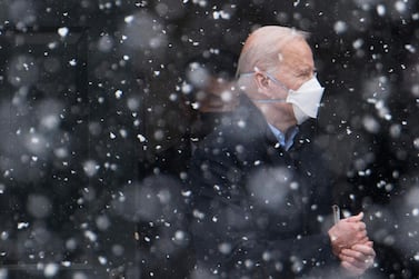 US President Joe Biden makes his way to his vehicle in the snow, after attending Mass at Saint Joseph on the Brandywine Church in Wilmington, Delaware. AFP