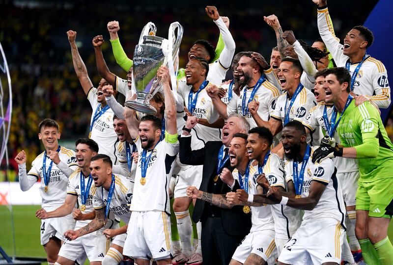 Real Madrid captain Nacho Fernandez lifts the Champions League trophy. PA