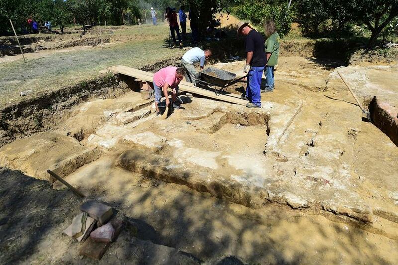 Local workers remove soil on the tomb of Ottoman Sultan Suleiman the Magnificent, near Szigetvar on September 2, 2016. The recent discovery of the tomb of Suleiman the Magnificent, considered the greatest Ottoman ruler, has raised hopes of a tourism boom in one of Hungary's most impoverished areas. Attila Kisbenedek/AFP