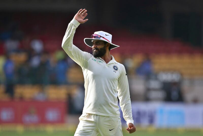India's Ravindra Jadeja stretches his arm as he walks to his fielding position during the second day of one-off cricket test match against Afghanistan in Bangalore, India, Friday, June 15, 2018. (AP Photo/Aijaz Rahi)