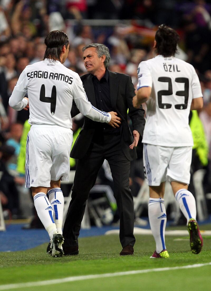 MADRID, SPAIN - APRIL 05:  Jose Mourinho of Real Madrid reacts to Sergio Ramos after Emmanuel Adebayor scores the opener the UEFA Champions League Quarter Final first leg match between Real Madrid and Tottenham Hotspur at Estadio Santiago Bernabeu on April 5, 2011 in Madrid, Spain.  (Photo by Clive Rose/Getty Images)