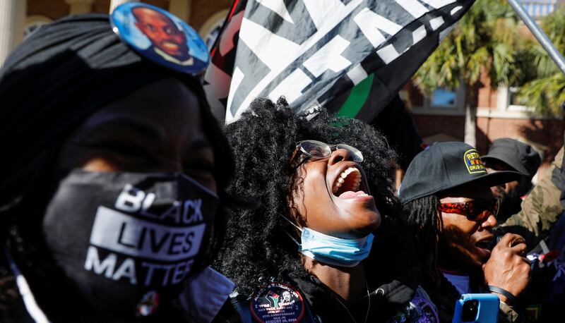 People react outside the Glynn County Courthouse after the jury reached a guilty verdict in the trial of William Bryan, Travis McMichael and Gregory McMichael, charged with the February 2020 death of 25-year-old Ahmaud Arbery, in Brunswick, Georgia. Reuters