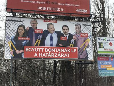Election posters by Hungary's ruling party Fidesz party labelled George Soros, centre, and its political rivals as opponents of the government's asylum policies. Paul Peachey / The National