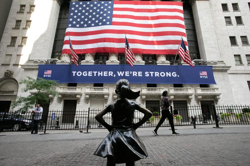 FILE - In this July 9, 2020 file photo, the Fearless Girl statue stands in front of the New York Stock Exchange in New York. U.S. stocks edged lower in early trading Tuesday, Dec. 8 as investors worried that rising virus cases will delay a full economic recovery while the world waits for wide distribution of a vaccine. (AP Photo/Mark Lennihan, File)