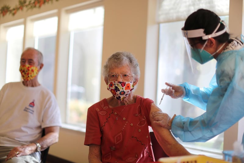Joyce Flippin, 83, receives a dose of the coronavirus vaccine at Mission Commons assisted-living community in Redlands, California, US. Reuters