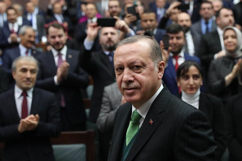 Turkish President Recep Tayyip Erdogan greets people during the Justice and Development Party (AK Party) group meeting at the Grand National Assembly of Turkey (TBMM) in Ankara, Turkey on January 16, 2018. / AFP PHOTO / ADEM ALTAN