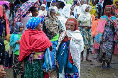 Displaced Amharas from different villages now controlled by Tigrayan forces in the North Gondar zone, gather in a kindergarten school housing the internally-displaced, in Debark, in the Amhara region of northern Ethiopia Wednesday, Aug.  25, 2021.  AP