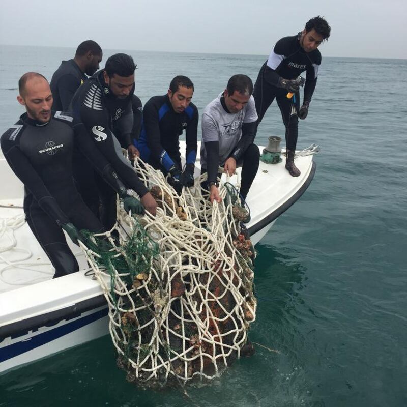 Divers help remove waste from a shipwreck that sank 56 years ago in Sharjah. Courtesy Sharjah Museums Department