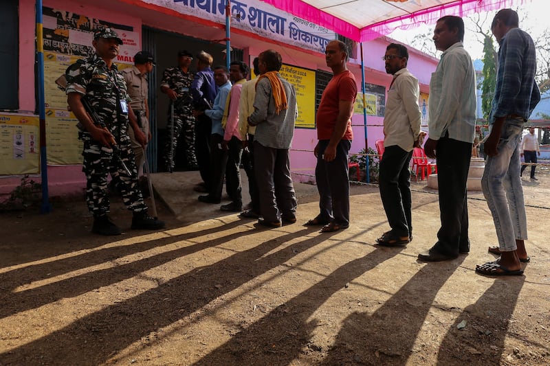 Voters stand in queue at a polling station in Chhindwara, Madhya Pradesh. AFP
