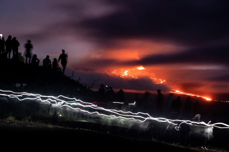 People gather to observe the eruption of the Mauna Loa Volcano in Hawaii. Reuters 