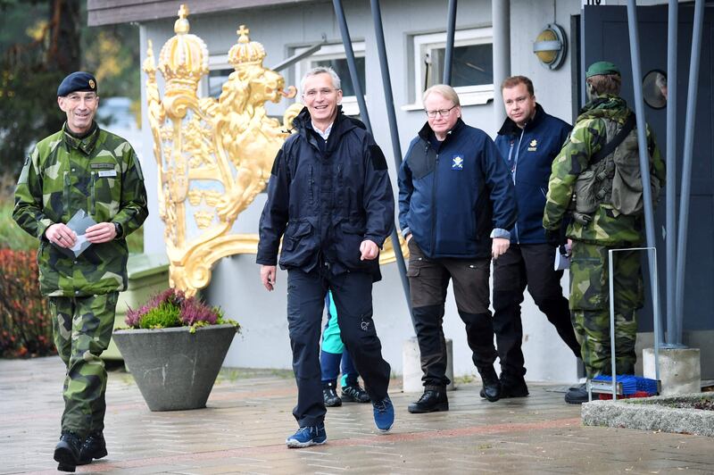 Nato Secretary-General Jens Stoltenberg, centre, inspects military exercises in Sweden in October. AFP