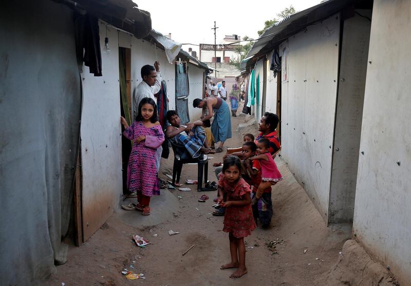 FILE PHOTO: People belonging to Rohingya Muslim community sit outside their makeshift houses on the outskirts of Jammu May 5, 2017. Picture taken on May 5, 2017. REUTERS/Mukesh Gupta/File Photo