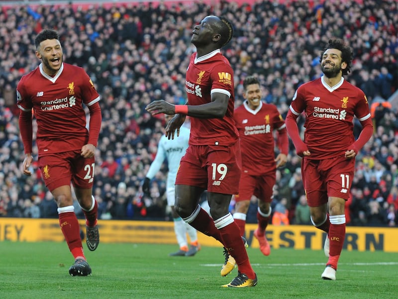 Liverpool's Sadio Mane, centre, celebrates scoring his sides fourth goal during the English Premier League soccer match between Liverpool and West Ham United at Anfield in Liverpool, England, Saturday, Feb. 24, 2018. (AP Photo/Rui Vieira)