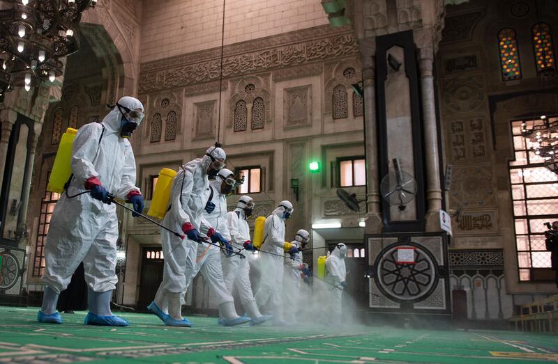 epa09126527 Workers wearing protective suits spray disinfectant in al-Fateh mosque as it is being prepared for prayers during the holy month of Ramadan, following the outbreak of the coronavirus disease (COVID-19), in Cairo, Egypt, 10 April 2021. Muslims around the world celebrate the holy month of Ramadan by praying during the night time and abstaining from eating, drinking, and sexual acts during the period between sunrise and sunset. Ramadan is the ninth month in the Islamic calendar and it is believed that the revelation of the first verse in Koran was during its last 10 nights.  EPA/Mohamed Hossam
