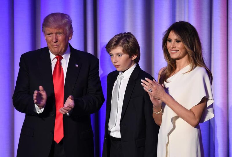 US President-elect Donald Trump arrives with his son Baron and wife Melania at the New York Hilton Midtown in New York. Trump stunned America and the world Wednesday, riding a wave of populist resentment to defeat Hillary Clinton in the race to become the 45th president of the United States. Saul Loeb / AFP