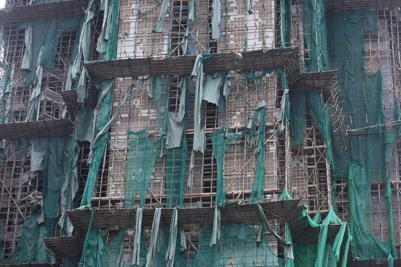 Protective scaffolding cloth is seen ripped on a building under construction after heavy winds in Macau. The death toll from Severe Typhoon Hato rose to at least 16 after the storm left a trail of destruction across southern China, blacking out Macau's mega-casinos and battering Hong Kong's skyscrapers. Anthony Wallace / AFP