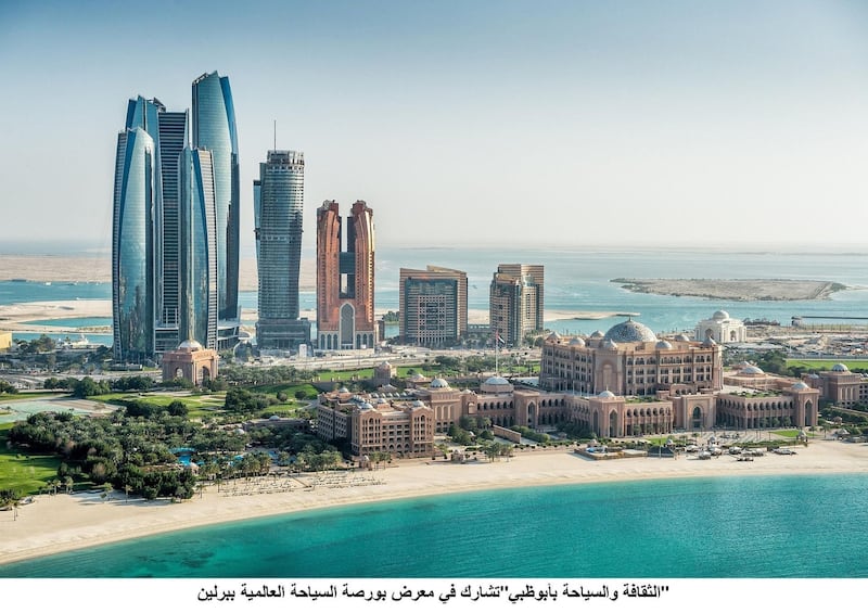 Helicopter point of view of sea and skyscrapers in Corniche bay in Abu Dhabi, UAE. Turquoise water and blue sky combined with building exterior.